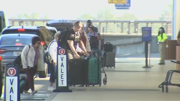 Driver carjacked at gunpoint after dropping off family at Orlando International Airport