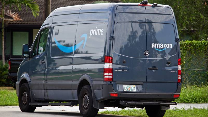 06-09-2019  Miami-Dade county Florida U.S.A. Amazon Prime delivery vehicle stops in residential neighborhood to deliver packages