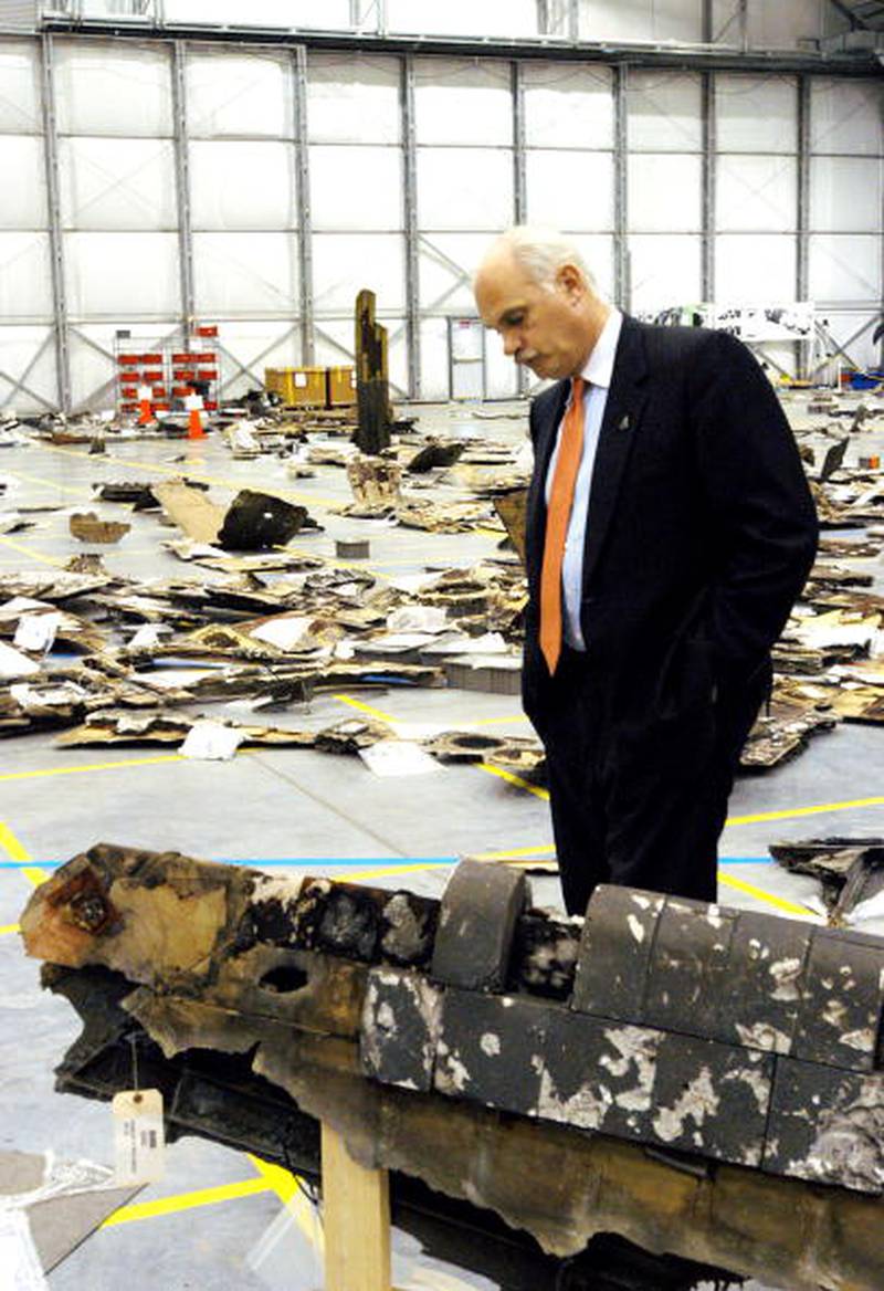 In this NASA handout, NASA Associate Administrator William F. (Bill) Readdy, Office of Space Flight, examines a piece of debris from Space Shuttle Columbia April 28, 2003 at the Kennedy Space Center, Floridia. More than 70,000 items have been delivered to the space center in the ongoing mishap investigation.  (Photo by NASA/Getty Images) (NASA HANDOUT)