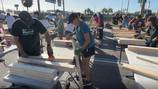 Volunteers build beds for children in need at Orlando Sanford International Airport 