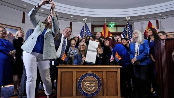Arizona governor's signing of abortion law repeal follows political fight by women lawmakers