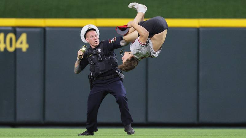 fan doing a backflip at a Cincinnati Reds game