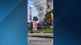 1 dead after car crashes into fireworks store, starting blaze