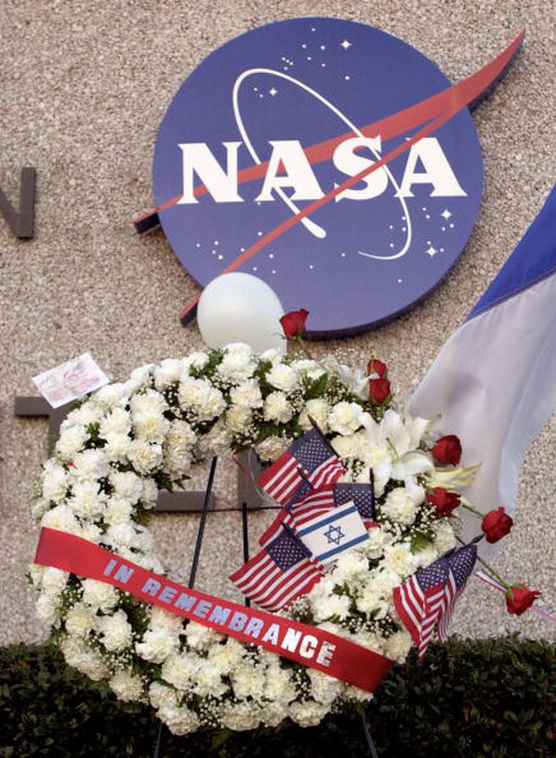 A wreath adorned with an Israeli and American flags stands in a makeshift memorial to the astronauts who were killed when the space shuttle Columbia exploded upon re-entry into Earth's atmosphere, outside NASA's Johnson Space Center February 1, 2003 in Houston, Texas. The seven members of the crew were killed when the shuttle broke up over Texas preparing to land at the Kennedy Space Center in Florida.  (Photo by Brett Coomer/Getty Images)