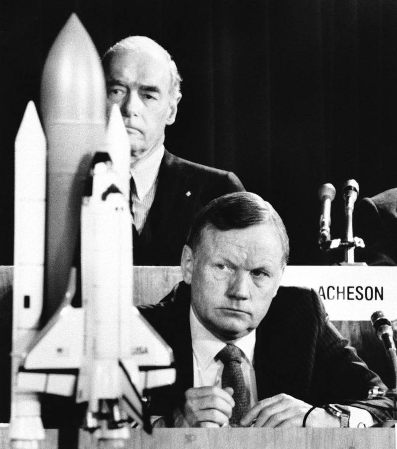 FILE - In this Feb. 11, 1986 file photo, former astronaut Neil Armstrong, a member of the presidential panel investigating the Space Shuttle Challenger explosion, listens to testimony before the commission in Washington, as David Acheson, a commission member, listens in the background. When Armstrong became the first man to walk on the moon, he captured the attention and admiration of millions of people around the world. Now fans of Armstrong and of space exploration have a chance to own artifacts and mementos that belonged to the modest man who became a global hero. The personal collection of Armstrong, who died in 2012, will be offered for sale in a series of auctions handled by Dallas-based Heritage Auctions. (AP Photo/Scott Stewart, File)