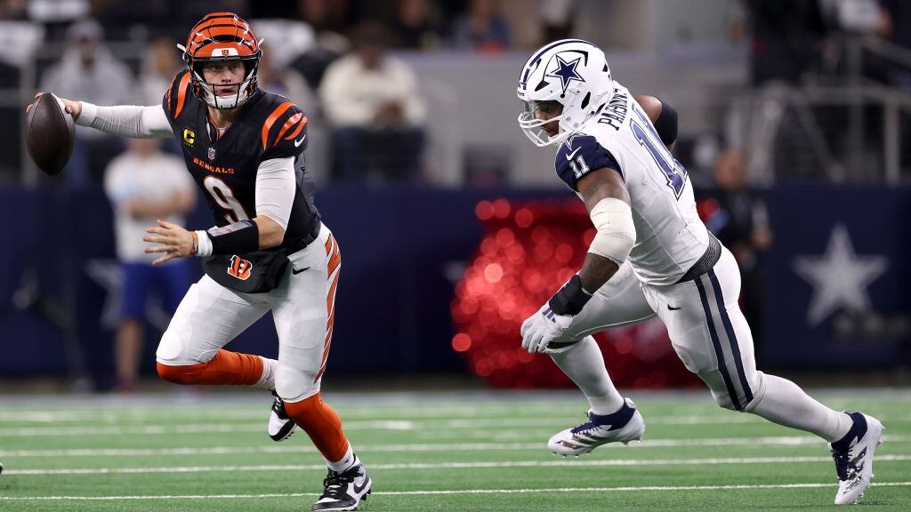 Joe Burrow #9 of the Cincinnati Bengals scrambles against Micah Parsons #11 of the Dallas Cowboys