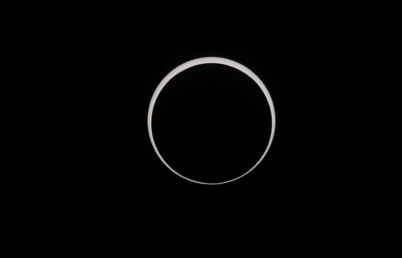 CAPITOL REEF NATIONAL PARK, UTAH - OCTOBER 14:  The moon crosses the sun as it exits the maximum eclipse during the Annular Solar Eclipse  on October 14, 2023 in Capitol Reef National Park, Utah. Starting at the Oregon coast and concluding on the east coast of South America an annular solar eclipse, where the moon is at its farthest from the Earth, will project a halo of sunlight around the moon's border.  (Photo by George Frey/Getty Images)
