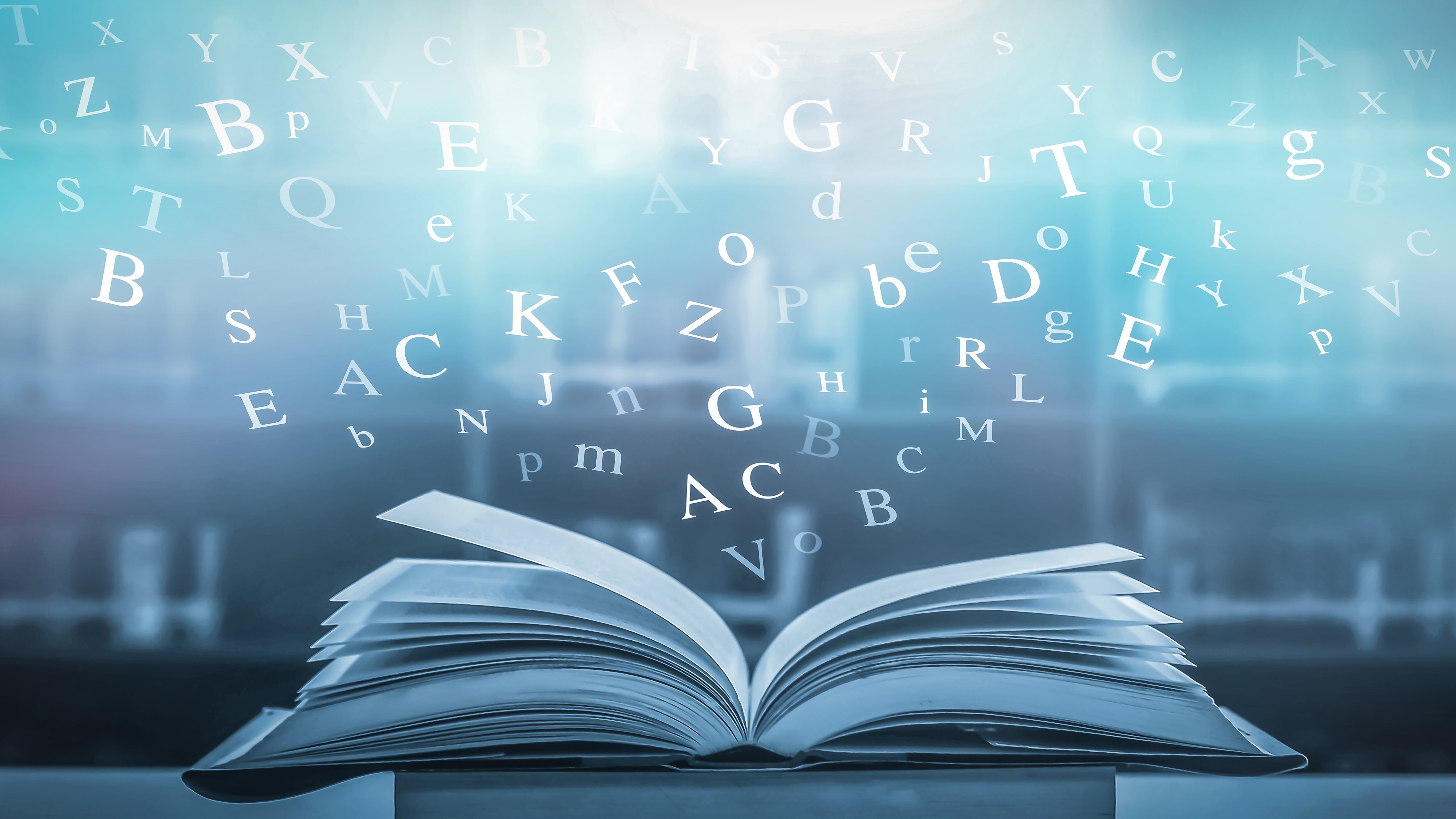 Dictionary with letters flying out concept