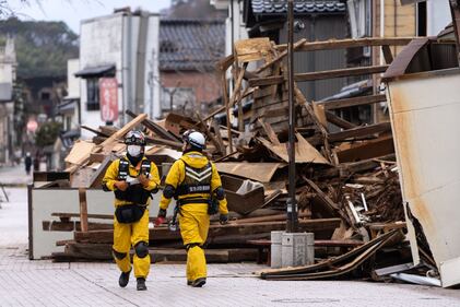 WAJIMA, JAPAN - JANUARY 05: Firefighters search for survivors in the aftermath of an earthquake on January 05, 2024 in Wajima, Japan. On New Year's Day, a series of major earthquakes reportedly killed at least 92 people, injured dozens more and destroyed a large amount of homes. The earthquakes, the biggest measuring 7.1 magnitude, hit the areas around Ishikawa, Toyama and Niigata in central Japan. (Photo by Tomohiro Ohsumi/Getty Images)