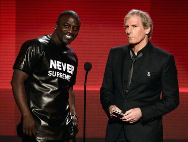 LOS ANGELES, CA - NOVEMBER 24: Singers Akon (L) and Michael Bolton speak onstage during the 2013 American Music Awards at Nokia Theatre L.A. Live on November 24, 2013 in Los Angeles, California. (Photo by Kevin Winter/Getty Images)
