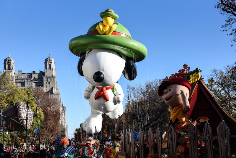 NEW YORK, NEW YORK - NOVEMBER 23: The Snoopy balloon floats in Macy's annual Thanksgiving Day Parade on November 23, 2023 in New York City. Thousands of people lined the streets to watch the 25 balloons and hundreds of performers march in this parade happening since 1924. (Photo by Stephanie Keith/Getty Images)