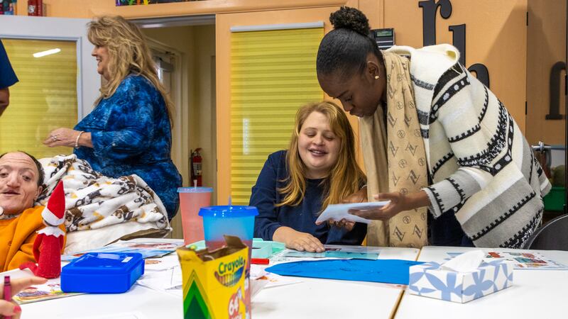 Adult residents at The Russell Home complete a project in class.