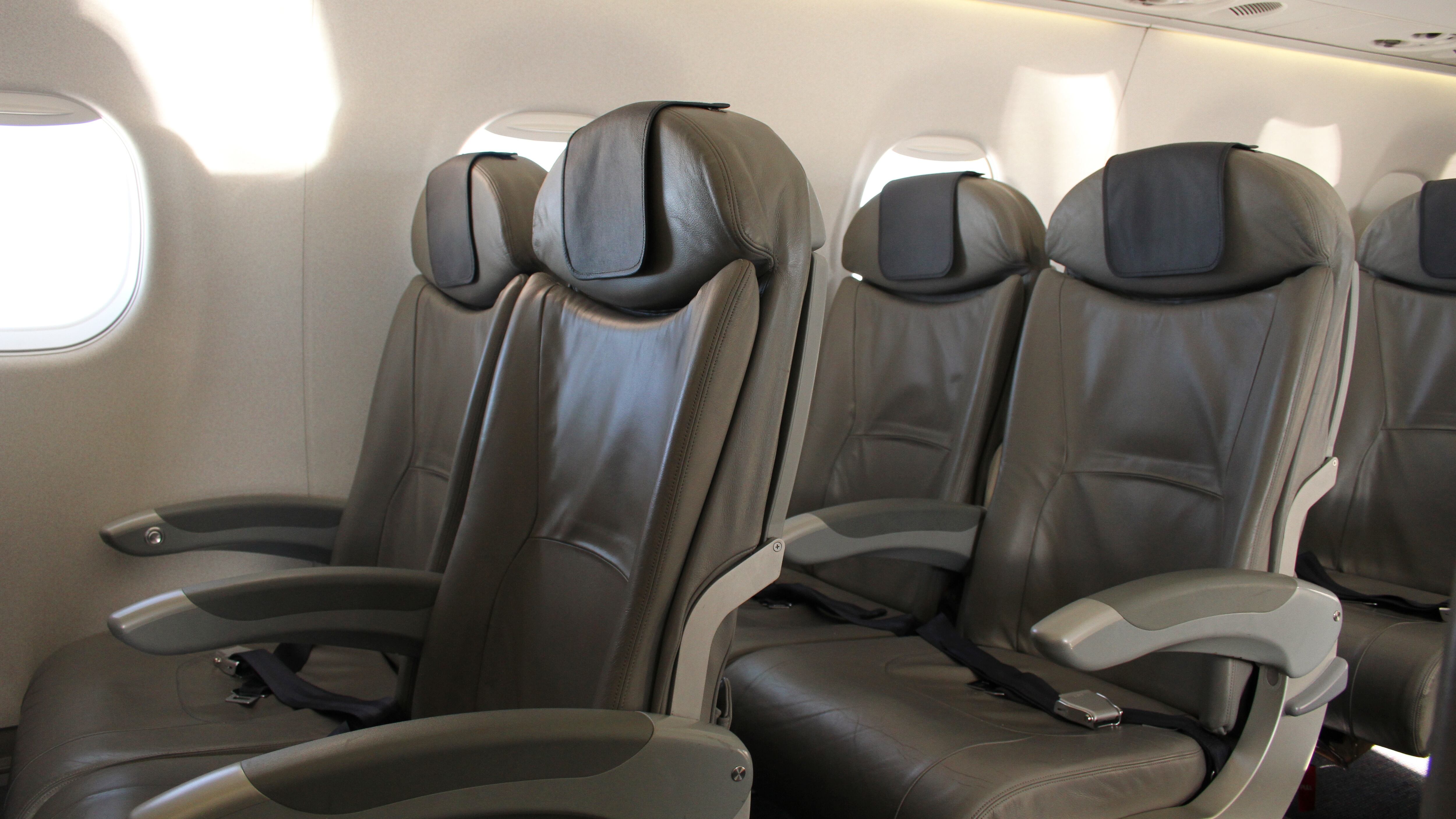 Airplane cabin. Rows of seats in gray.