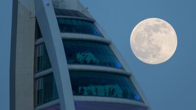 The Full Snow Moon rises behind the Spinnaker tower in Portsmouth, Hampshire.