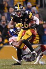 Pittsburgh Steelers running back Le'Veon Bell (26) is tackled by New York Giants strong safety Landon Collins (21) during the first half of an NFL football game in Pittsburgh, Sunday, Dec. 4, 2016.