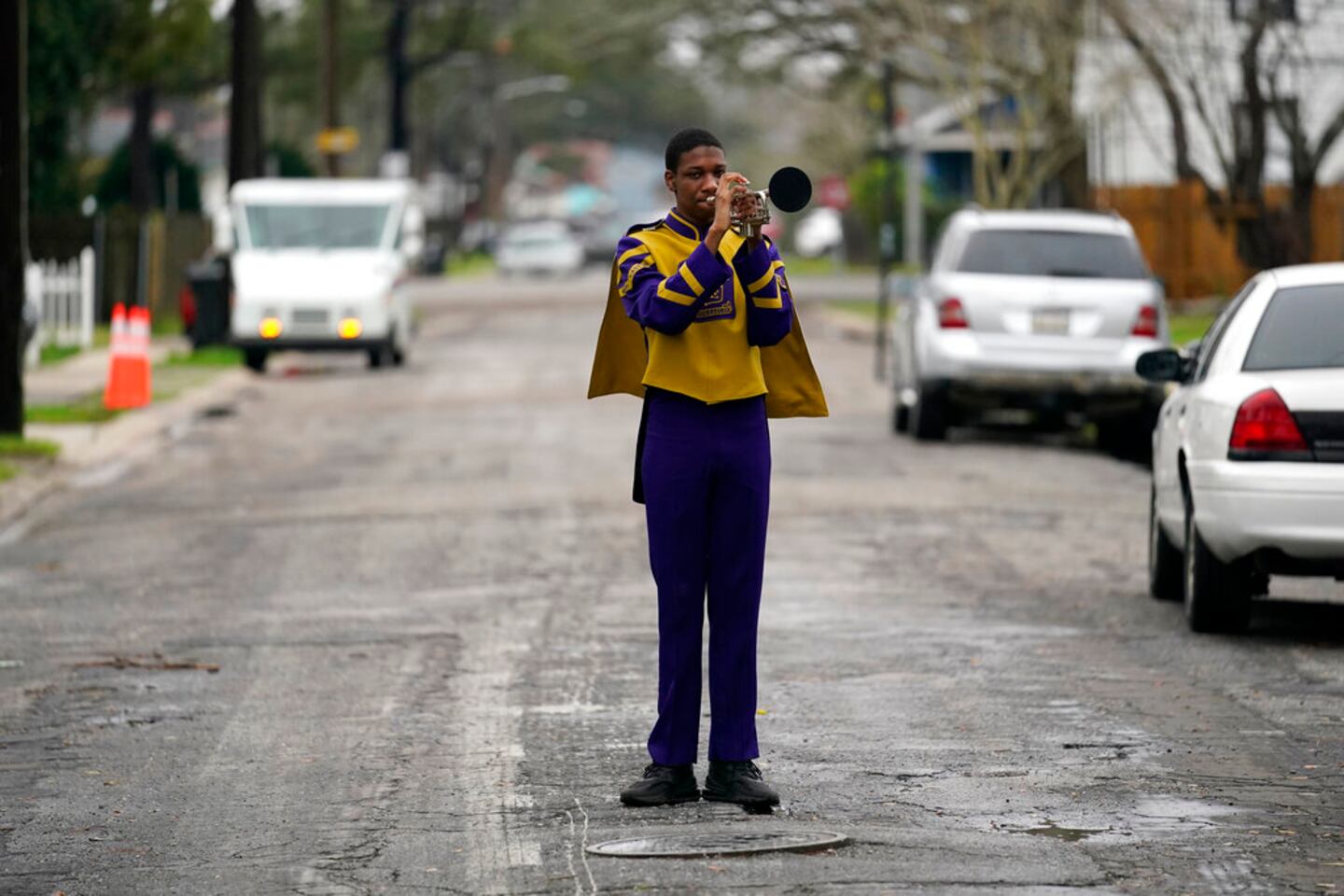 Elvin King III a senior at Warren Easton High and member of their marching band, which will not march because parades are cancelled, poses for a portrait in front of his home in New Orleans, Friday, Feb. 12, 2021. New Orleans' annual pre-Lenten Mardi Gras celebration is muted this year because of the coronavirus pandemic. Parades canceled. Bars closed. Crowds suppressed. Mardi Gras joy is muted this year in New Orleans as authorities seek to stifle the coronavirus's spread. And it's a blow to the tradition-bound city's party-loving soul.