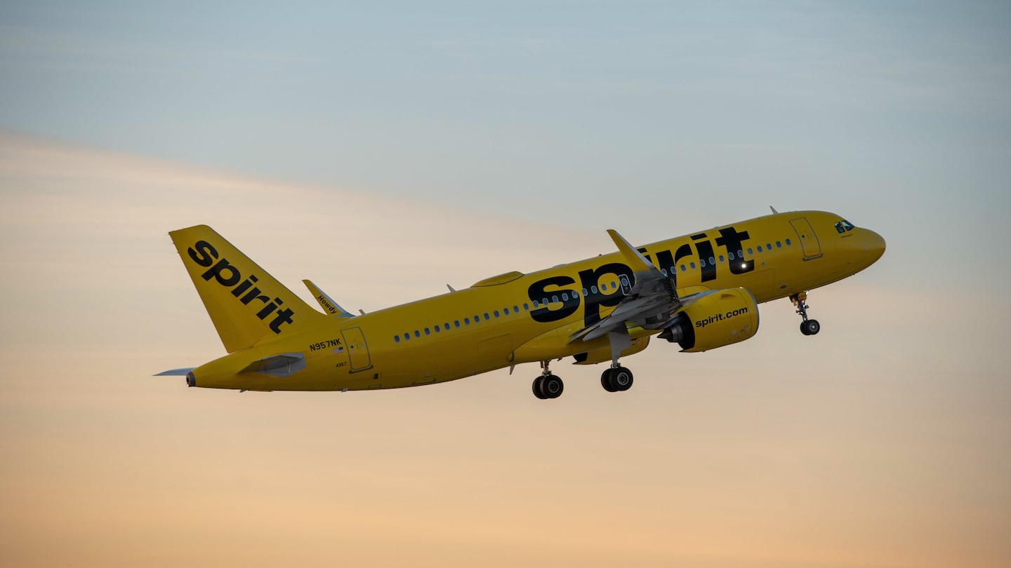 Spirit Airlines plane flying in the air.