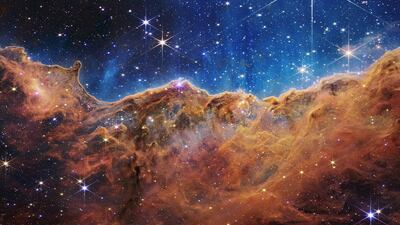 This landscape of “mountains” and “valleys” speckled with glittering stars is actually the edge of a nearby, young, star-forming region called NGC 3324 in the Carina Nebula. Captured in infrared light by NASA’s new James Webb Space Telescope, this image reveals for the first time previously invisible areas of star birth.