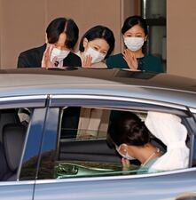 Japan's Princess Mako, in a car, is waved by her parents Crown Prince Akishino, Crown Princess Kiko, center, and her sister Princess Kako before leaving her home in Akasaka Estate in Tokyo Tuesday, Oct. 26, 2021. Mako and her commoner boyfriend Kei Komuro tied the knot Tuesday without wedding celebration in a marriage that has split the public opinion over her would-be mother-in-law’s financial controversy.